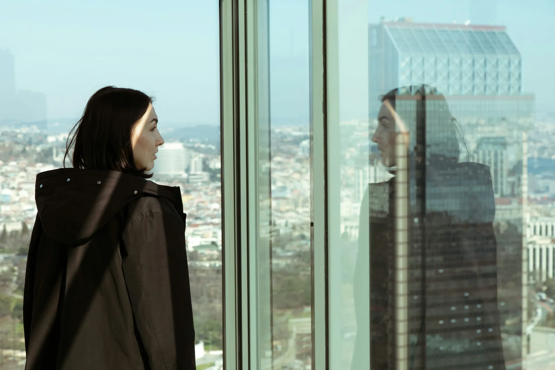 Executive looking out a high-rise window over the city